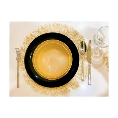 a black plate sitting on top of a table with silverware at Bostay in Casablanca