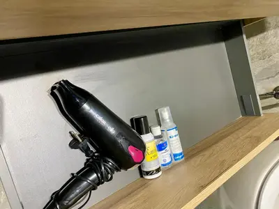 a black bottle sitting on a shelf next to medicines at Bostay in Casablanca