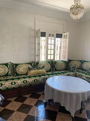 a living room with a couch and a table at Villa Casablanca-Sidi Rahal à 5 min de la plage in Sidi Rahal