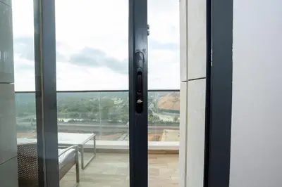 a sliding glass door with a view of a table at Appartement Royal in Beni Brour