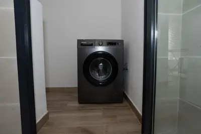 a washer and dryer sitting in a room at Appartement Royal in Beni Brour