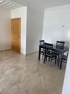 a dining room with a black table and chairs at Casabay sidirehal in Sidi Rahal