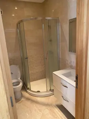 a bathroom with a shower and a toilet and a sink at Casabay sidirehal in Sidi Rahal