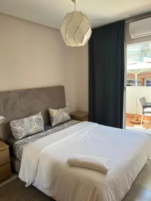 a bedroom with a large white bed and a window at Residence le 11 in Casablanca