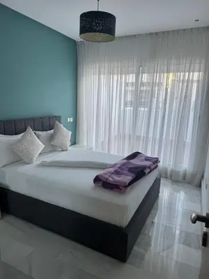 a bedroom with a large bed with a large window at Residence le 11 in Casablanca
