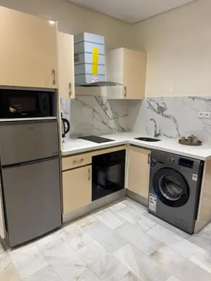 a kitchen with a washing machine and a washer at Residence le 11 in Casablanca