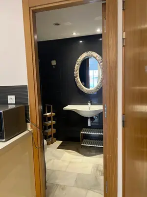 a bathroom with a sink and a mirror at Residence le 11 in Casablanca