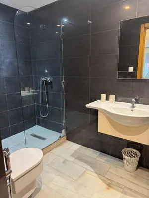 a bathroom with a shower and a toilet and a sink at Residence le 11 in Casablanca
