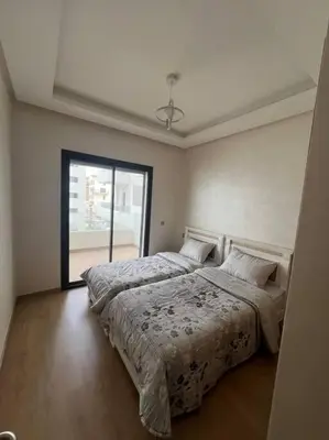 a bedroom with two beds and a large window at Trendy Condo - Stunning Views in Aïn Harrouda