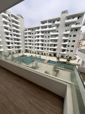 a balcony of a building with two large buildings at Trendy Condo - Stunning Views in Aïn Harrouda