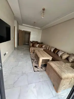 a living room with a couch and a table at Trendy Condo - Stunning Views in Aïn Harrouda