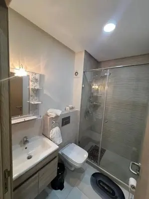 a bathroom with a shower and a toilet and a sink at Trendy Condo - Stunning Views in Aïn Harrouda
