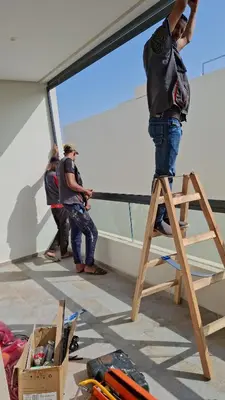 a man standing on a ladder in a room at Magic housse in Pont Blondin
