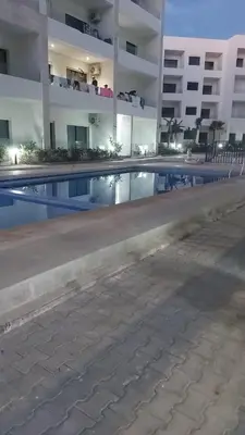 an empty swimming pool in front of a building at Magic housse in Pont Blondin