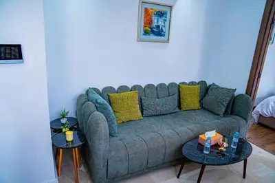 a living room with a couch and two tables at R102- Stylish and Functional 1 BR Apartment at the center of Belvedere in Casablanca