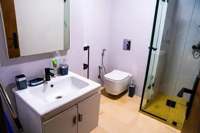 a bathroom with a sink and a shower and a toilet at R102- Stylish and Functional 1 BR Apartment at the center of Belvedere in Casablanca