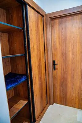 a wooden cabinet with a door in a room at R102- Stylish and Functional 1 BR Apartment at the center of Belvedere in Casablanca