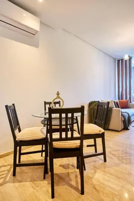 a dining room with a glass table and chairs at Casablanca Maarif in Maarif