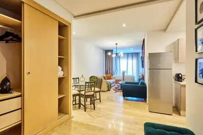 a kitchen and a living room with a refrigerator at Casablanca Maarif in Maarif
