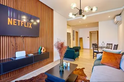 a living room with a television on a wall at Casablanca Maarif in Maarif