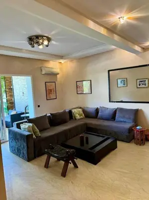a living room with a couch and a coffee table at La perle de Tamaris in Casablanca