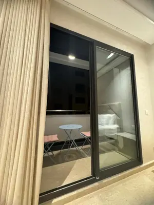 a room with sliding glass doors and a table at Appartement de prestige à Casablanca in Casablanca