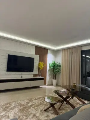 a living room with a flat screen tv on a wall at Appartement de prestige à Casablanca in Casablanca