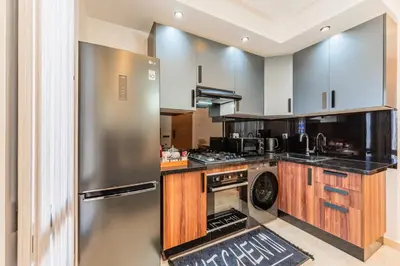 a large kitchen with a stainless steel refrigerator at Casablanca Centre Confort Luxe Emplacement idéal in Maarif