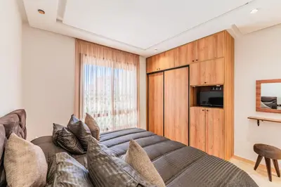 a living room with a couch and a television at Casablanca Centre Confort Luxe Emplacement idéal in Maarif