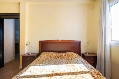 a bedroom with a bed and two night stands at Résidence beach house in Dar Bouazza
