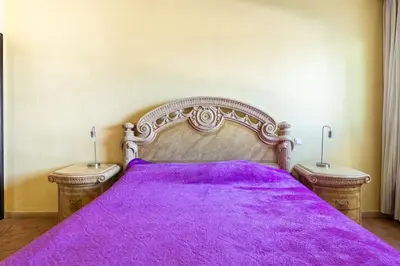 a bedroom with a purple bed with two night stands at Résidence beach house in Dar Bouazza