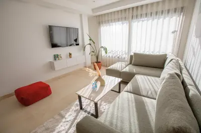 a living room with a couch and a table at Haut Standing 2-Bedroom Apartment in Gauthier in Casablanca