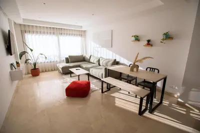 a living room with a couch and a table at Haut Standing 2-Bedroom Apartment in Gauthier in Casablanca