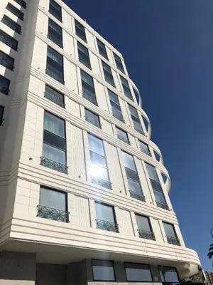 a tall building with windows on the side of it at Haut Standing 2-Bedroom Apartment in Gauthier in Casablanca
