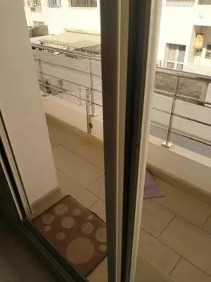 a sliding glass door with a view of a balcony at Studio Charmant & Cosy à Agdal in Gare de Rabat-Aguedal