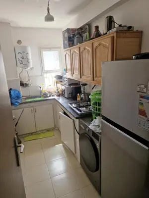 a kitchen with a refrigerator and a stove top oven at Appartement à Louer à Casablanca in Casablanca