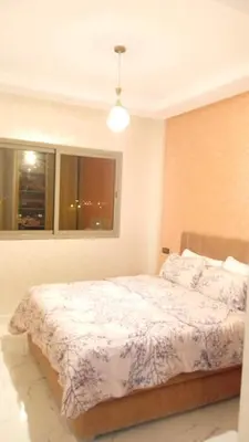 a bedroom with a bed in a room with a window at Welcomeمرحبا in Casablanca