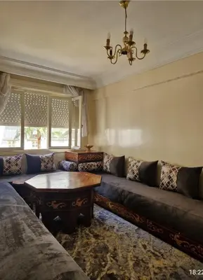 a living room with a couch and a table at Residence Louma in Mohammedia