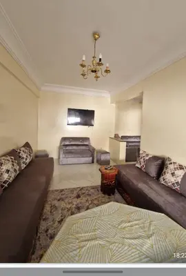 a living room with a couch and a bed at Residence Louma in Mohammedia