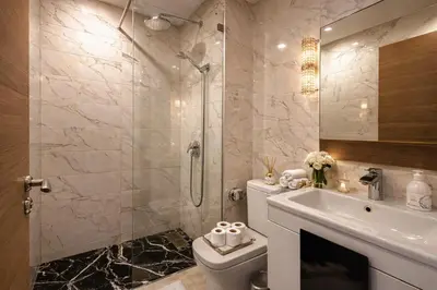 a bathroom with a toilet and a shower and a sink at Luxury 2Ch Face Plage 3 Piscines Jardin in Tamaris