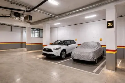 a car parked in a garage with a bed at Luxury 2Ch Face Plage 3 Piscines Jardin in Tamaris