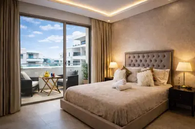 a bedroom with a large bed and a balcony at Luxury 1Ch Maarif Garage Fibre Netflix in Maarif
