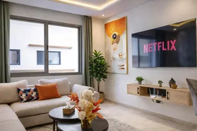 a living room with a couch and a tv at Luxury 1Ch Maarif Garage Fibre Netflix in Maarif
