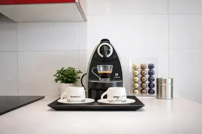 a coffee machine with two cups on a tray at Luxury 1Ch Maarif Garage Fibre Netflix in Maarif