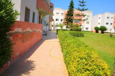 a sidewalk next to a building with a hose at Mohammedia Appartement in Mohammedia