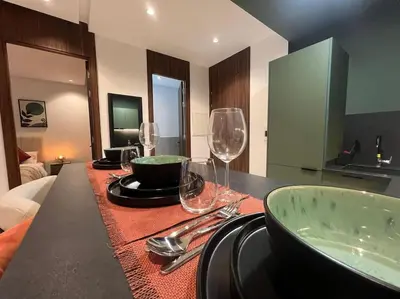 a table with wine glasses on top of it at Luxury Residence So Stylish & Bright Appartement Hotel Au Coeur de Casablanca prés de Carrefour et 3 Min de La Gare Ferroviere Oasis in Casablanca
