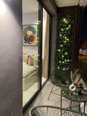 a living room with a couch and a table and chairs at Luxury Residence So Stylish & Bright Appartement Hotel Au Coeur de Casablanca prés de Carrefour et 3 Min de La Gare Ferroviere Oasis in Casablanca