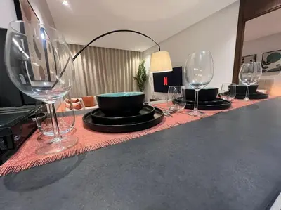 a row of wine glasses sitting on a table at Luxury Residence So Stylish & Bright Appartement Hotel Au Coeur de Casablanca prés de Carrefour et 3 Min de La Gare Ferroviere Oasis in Casablanca