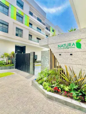 a building with a sign on the side of it at Appartement Dahlia - Haut Standing - Mohammedia Natura Living in Mohammedia