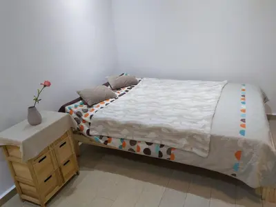 a bedroom with a bed with a nightstand and a bed sidx sidx sidx sidx at Sweet Home in Maarif